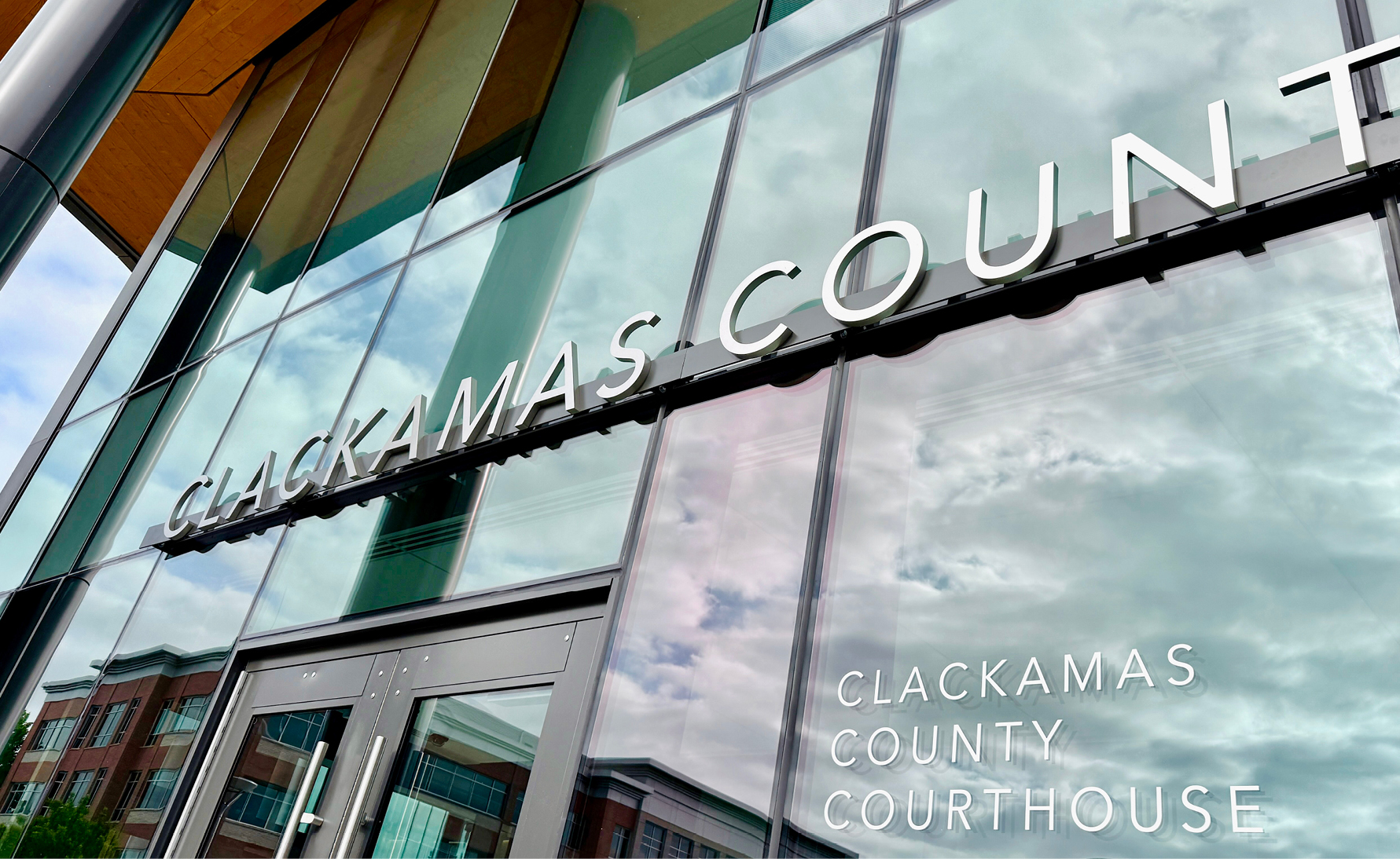 The front entrance of the new Clackamas County Courthouse with signage designed by Mayer/Reed