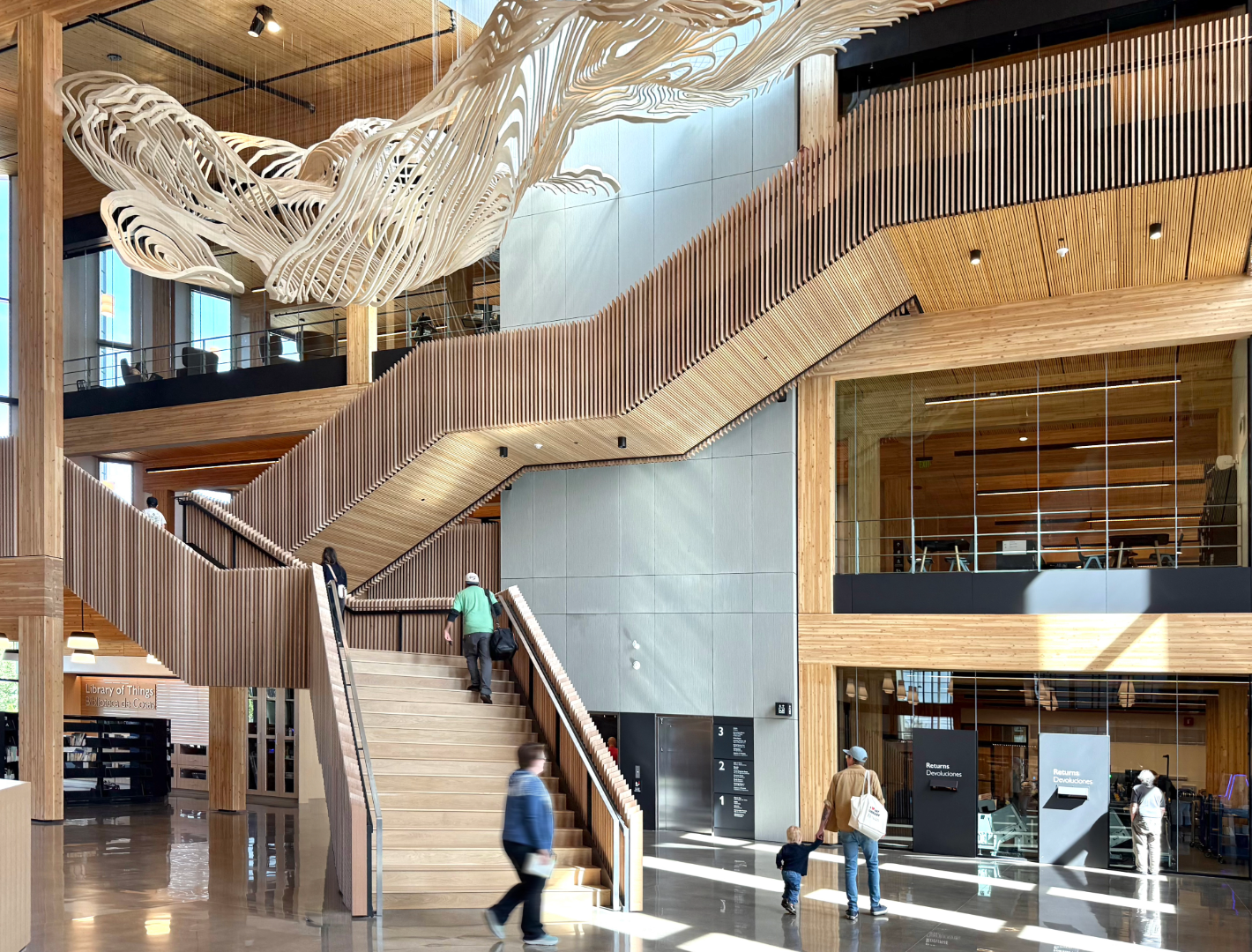 Photo of the staircase and hanging art piece in the interior space of Central Library