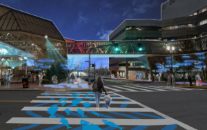 A rendering of Salmon Street at night at the World Trade Center with artistic lighting in the skyway and colorful ground-plane graphics in the crosswalk