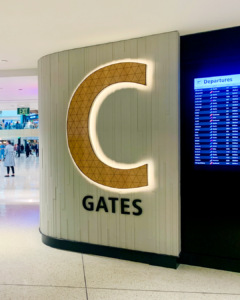 A large illuminated "C" marks the entrance of the C Concourse at Seattle-Tacoma International Airport